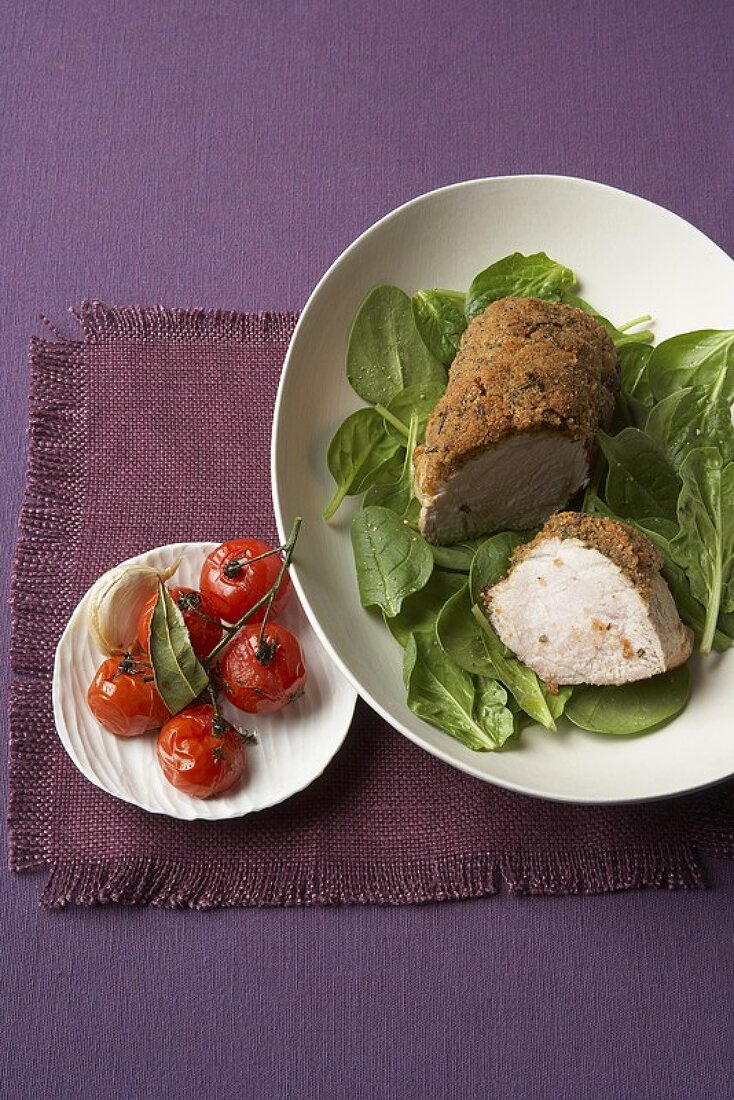 Veal with rosemary crust on spinach with cocktail tomatoes
