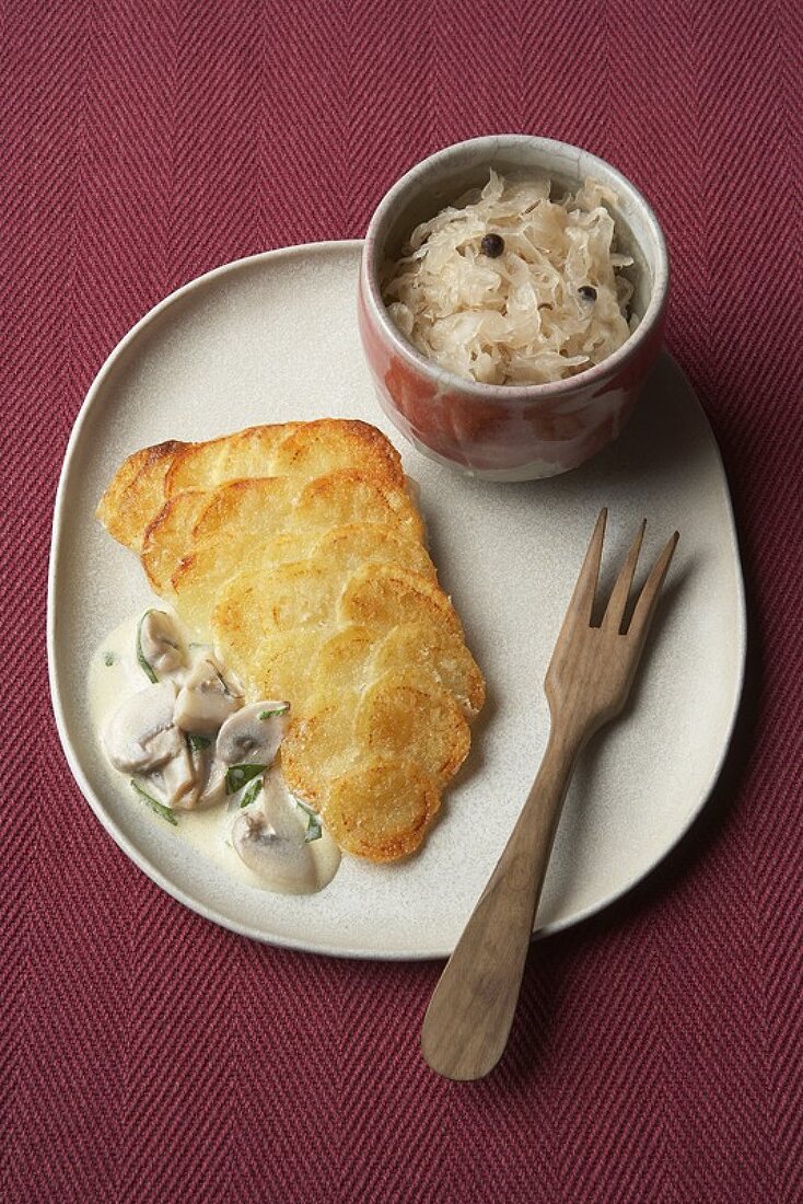 Zander mit Kartoffelschuppen, Champigonsauce und Sauerkraut