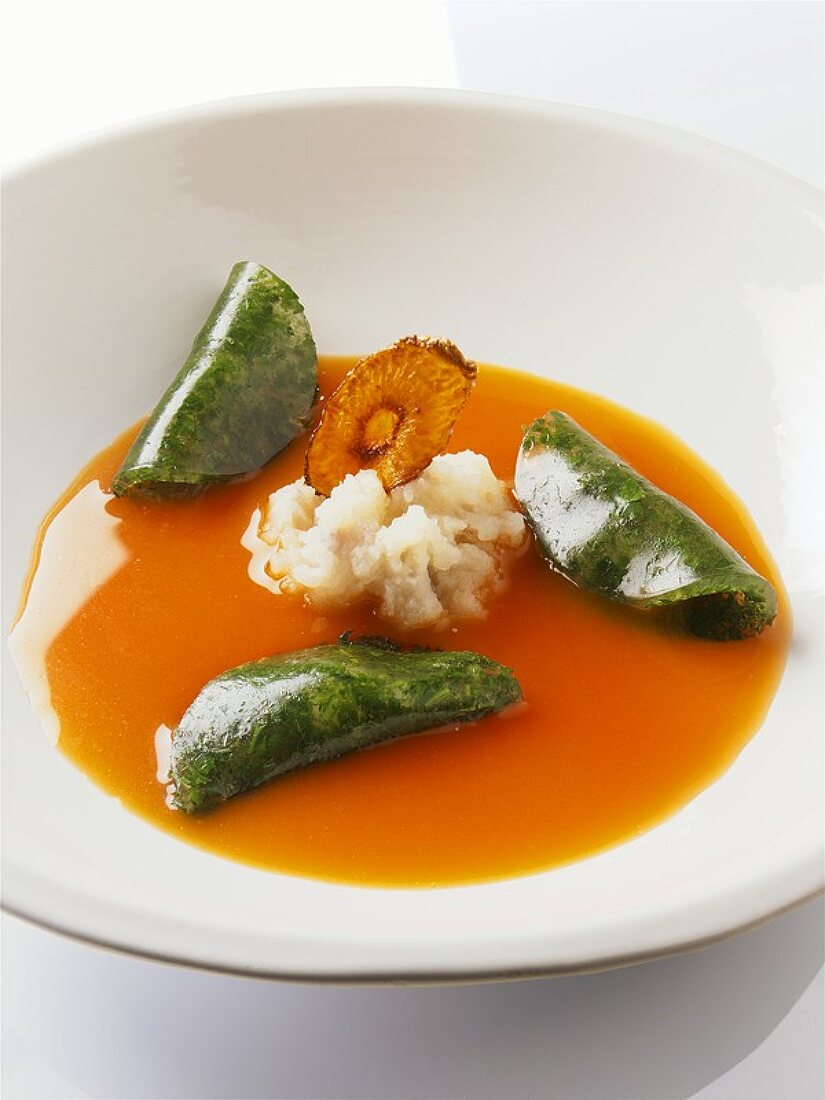 A plate of carrot bouillon with herb jelly