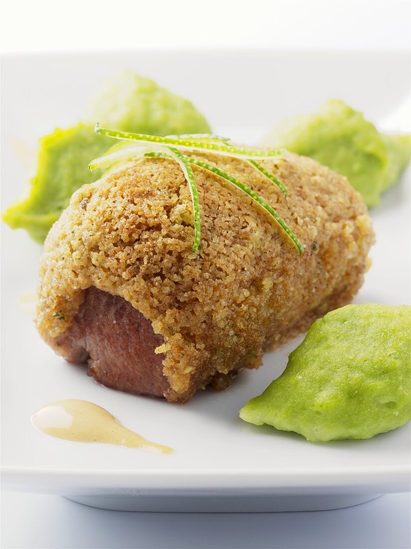 Loin of lamb baked in a crust with pea puree