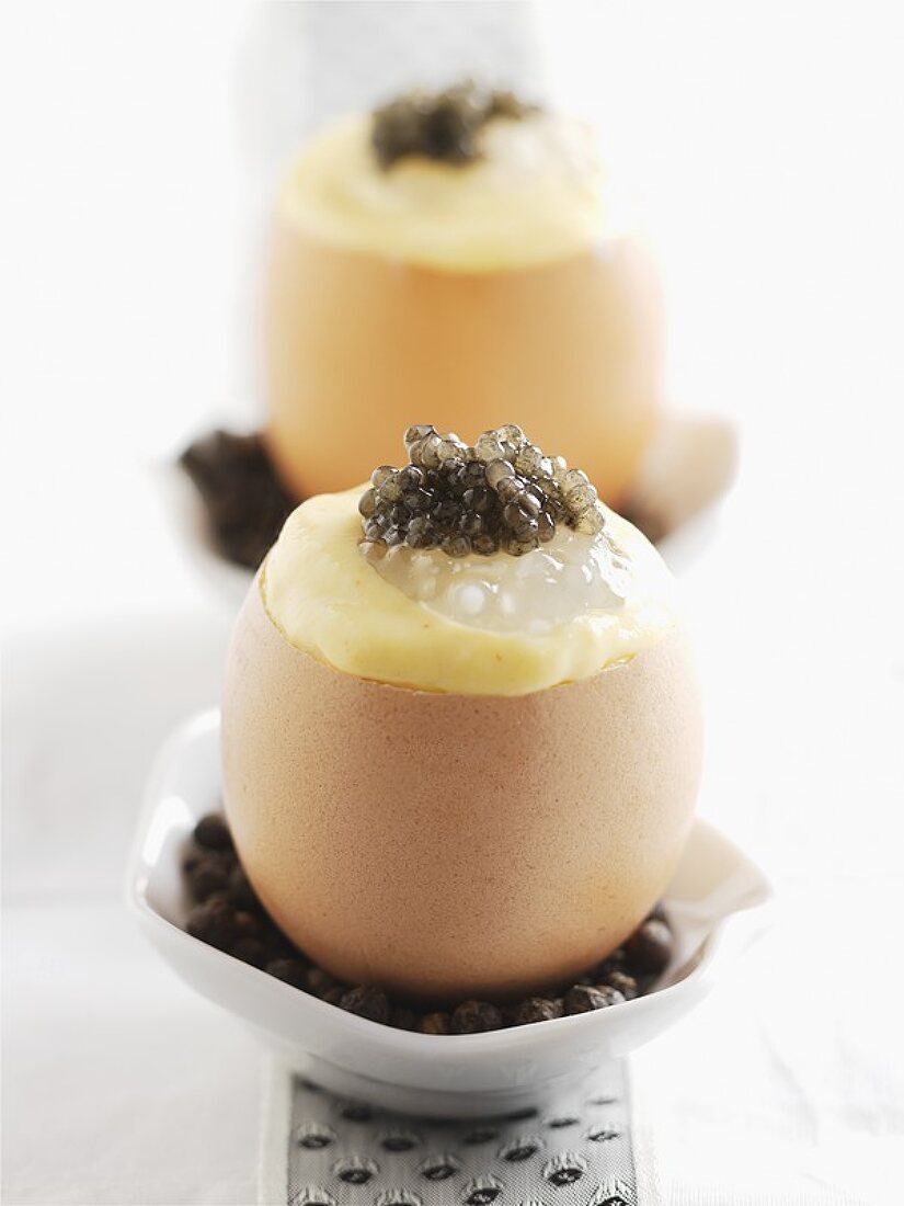 Two eggshells filled with caviar