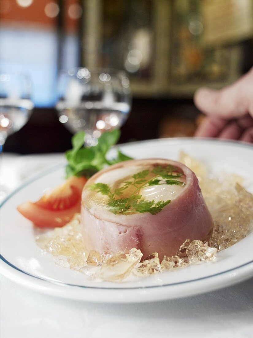 Serving egg in aspic with ham in a restaurant