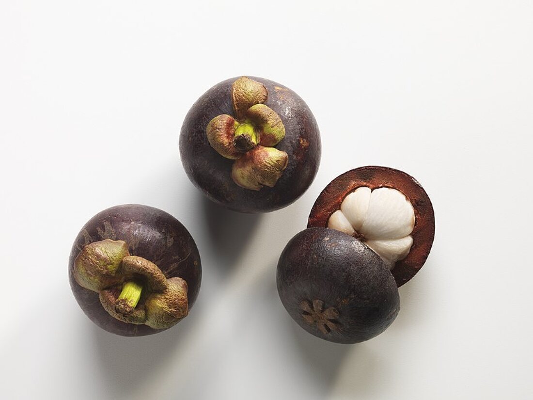 Mangosteens, two whole and one half