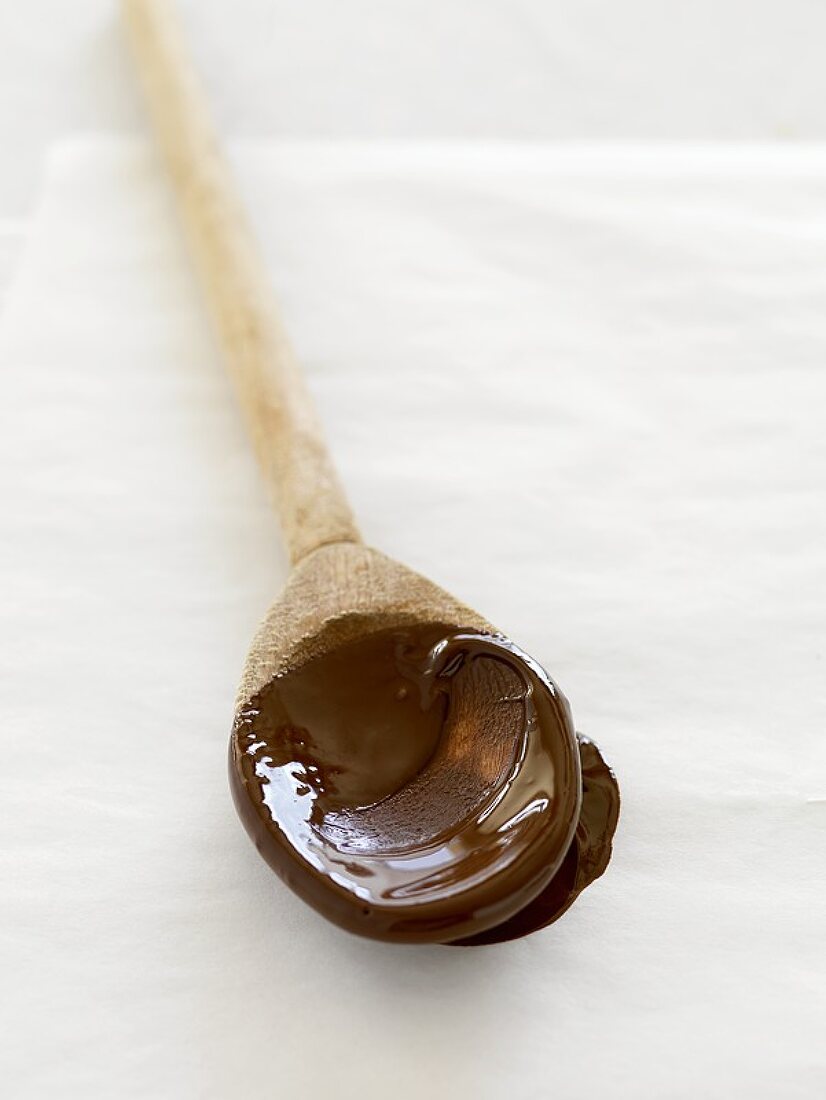 Melted chocolate on a wooden spoon