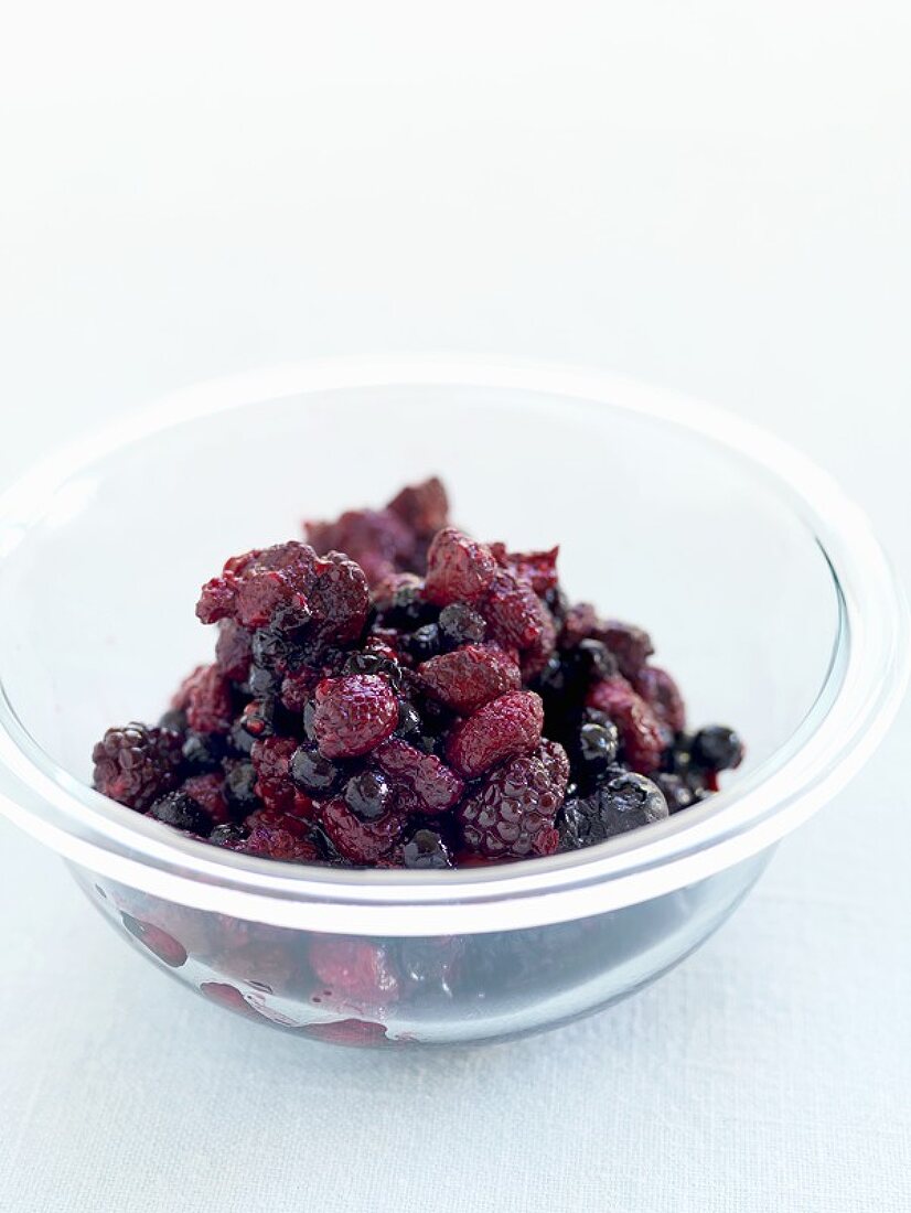 Thawed mixed berries in a glass dish