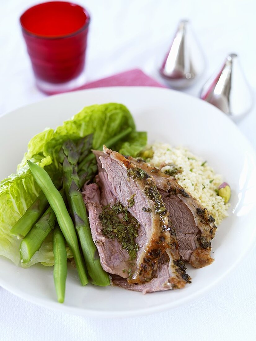 Slices of leg of lamb with couscous and salad