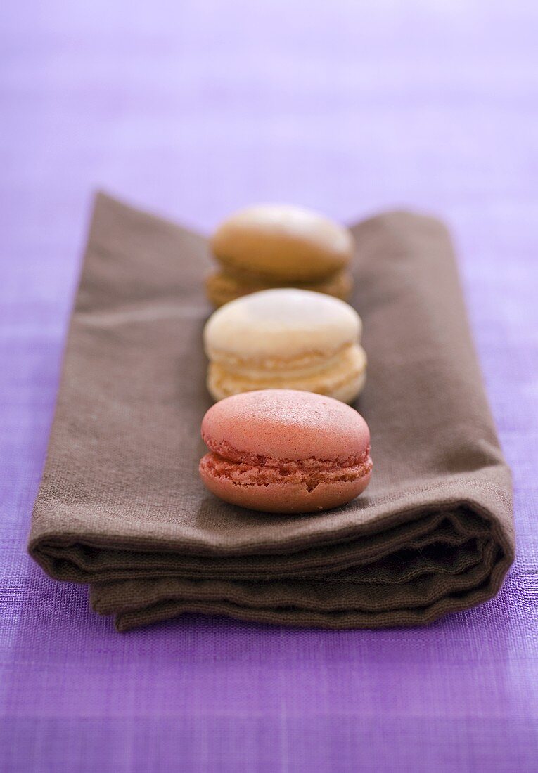Three filled macarons on a fabric napkin