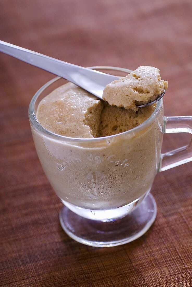 Coffee mousse with spoon in a glass cup