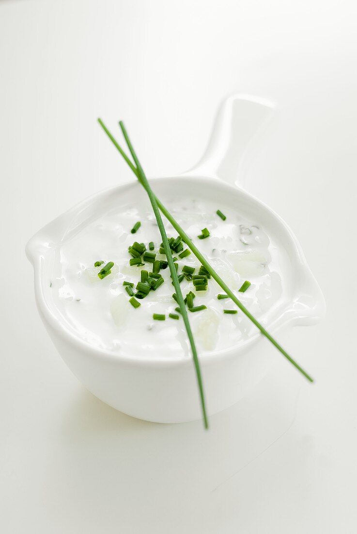 Sour cream with chives in a sauce-boat