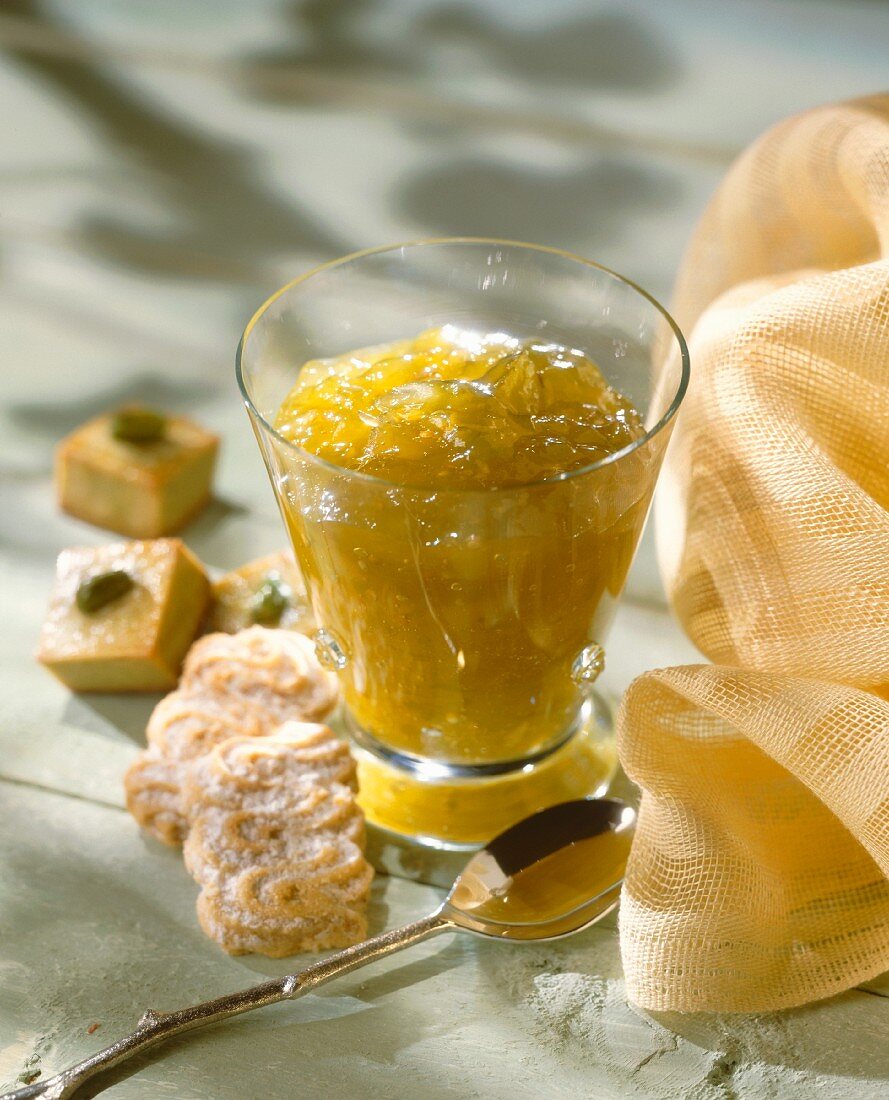 Ein Glas Orangen-Feigen-Konfitüre mit Keksen