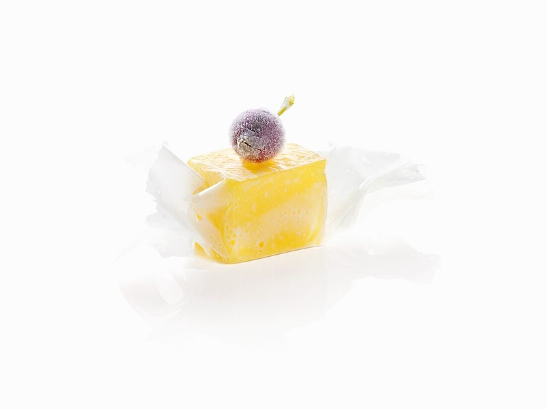Molecular cuisine: mango in milk paper with frozen berry