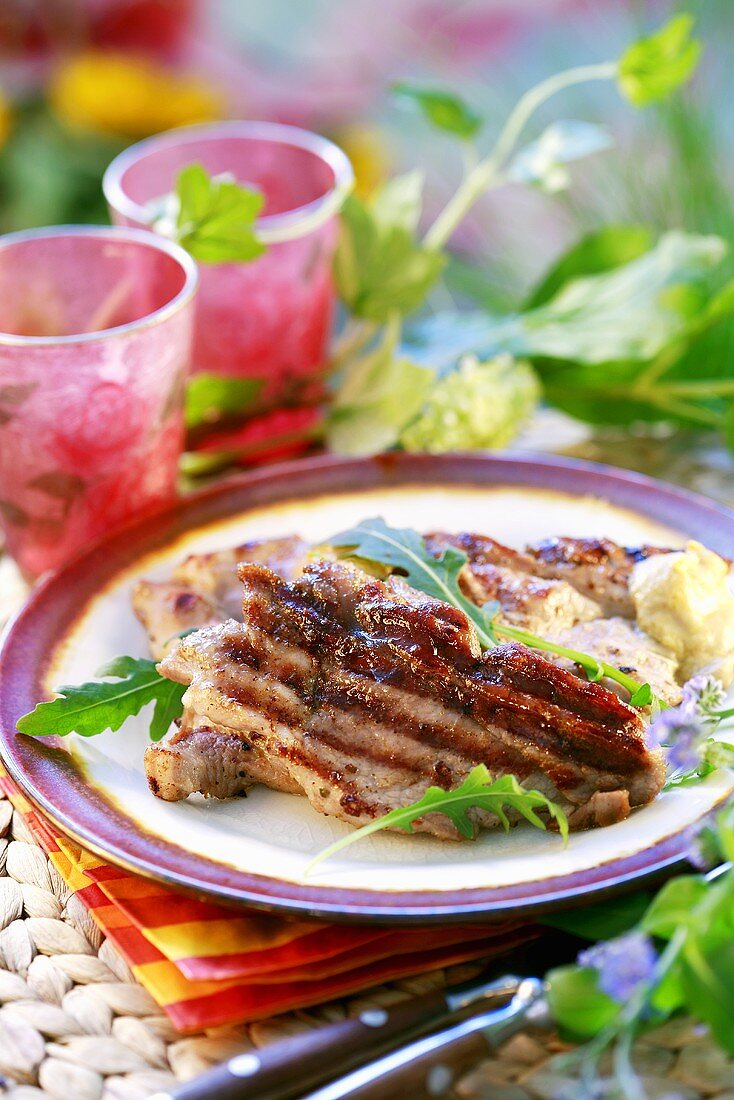 Grilled pork neck steak with rocket and mayonnaise