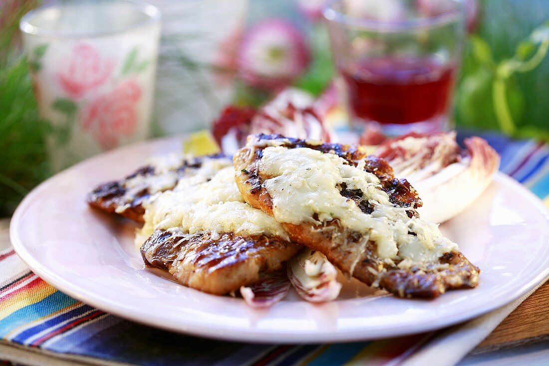 Grilled ham slices with cheese on radicchio