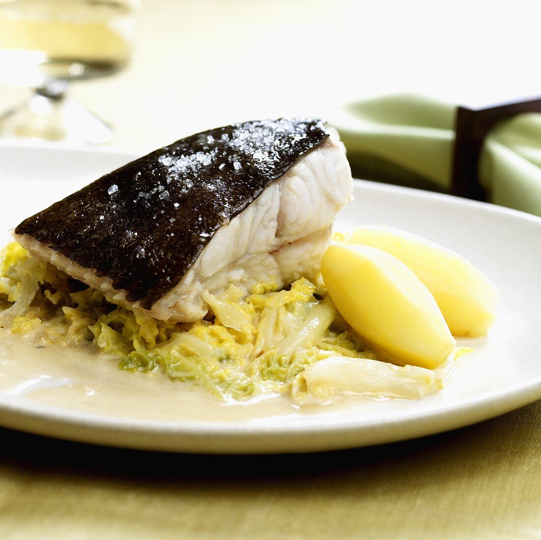 Poached cod on savoy cabbage with potatoes