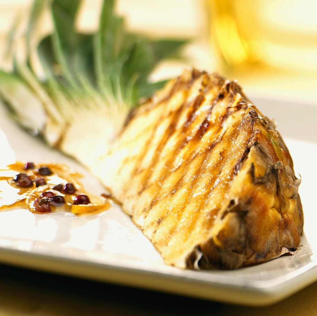 Grilled pineapple quarter & orange sauce with pink peppercorns
