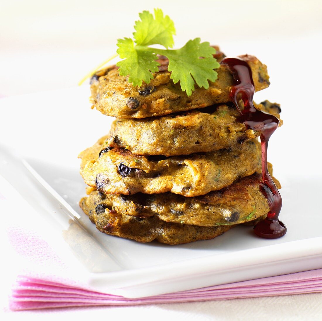 Five pumpkin and elderberry pancakes with maple syrup