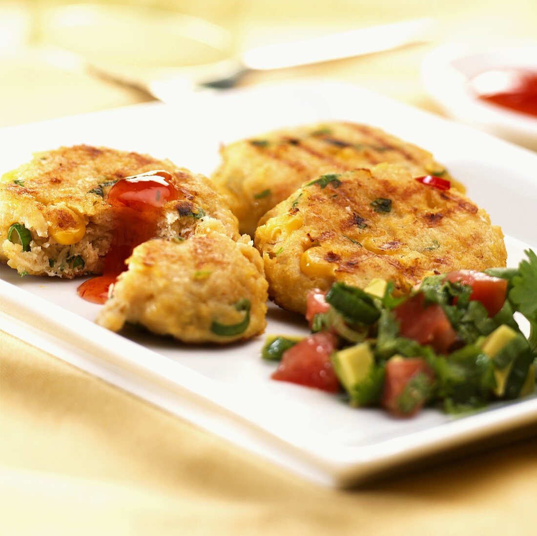 Fish cakes with tomato and avocado salsa