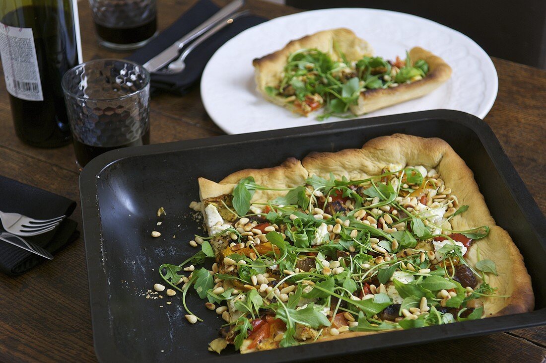 Vegetarian pizza with rocket & ricotta topping in baking tin