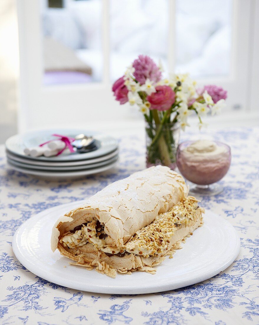 A meringue roulade with cream and hazelnut filling