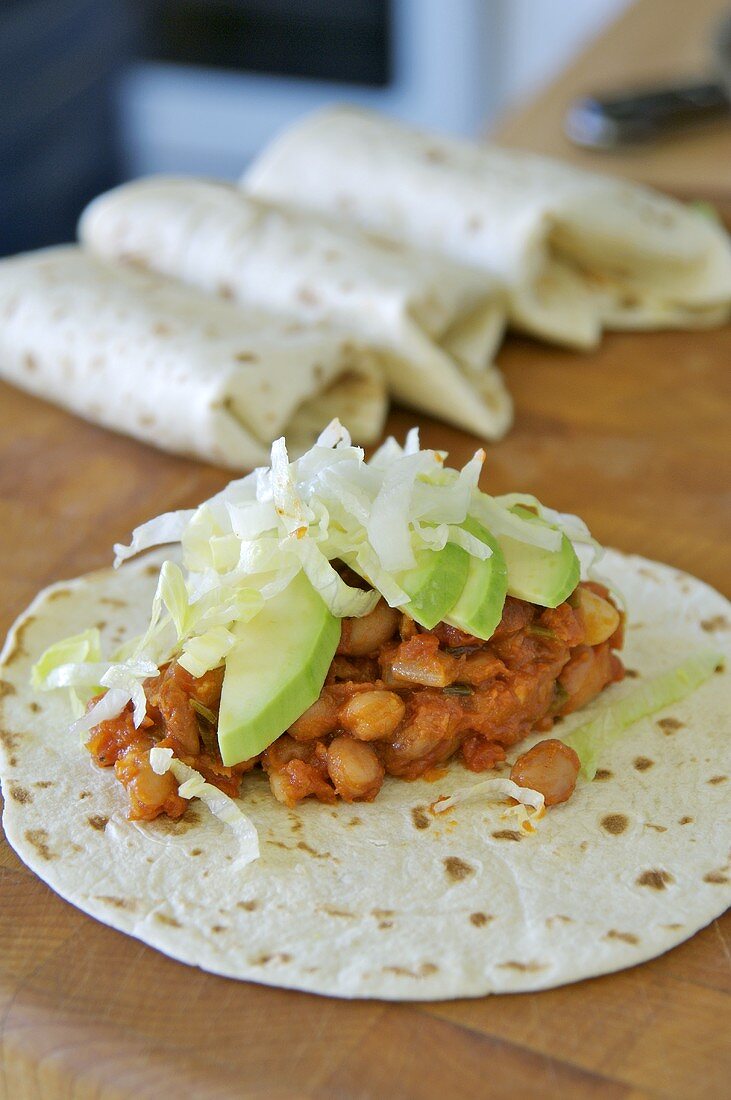 Wraps with beans, iceberg lettuce & avocado, rolled & unrolled