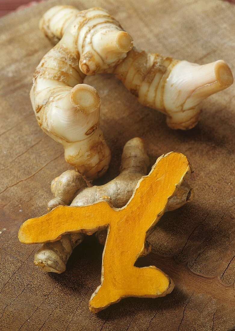 Galangal root, turmeric roots, whole and with cut surface