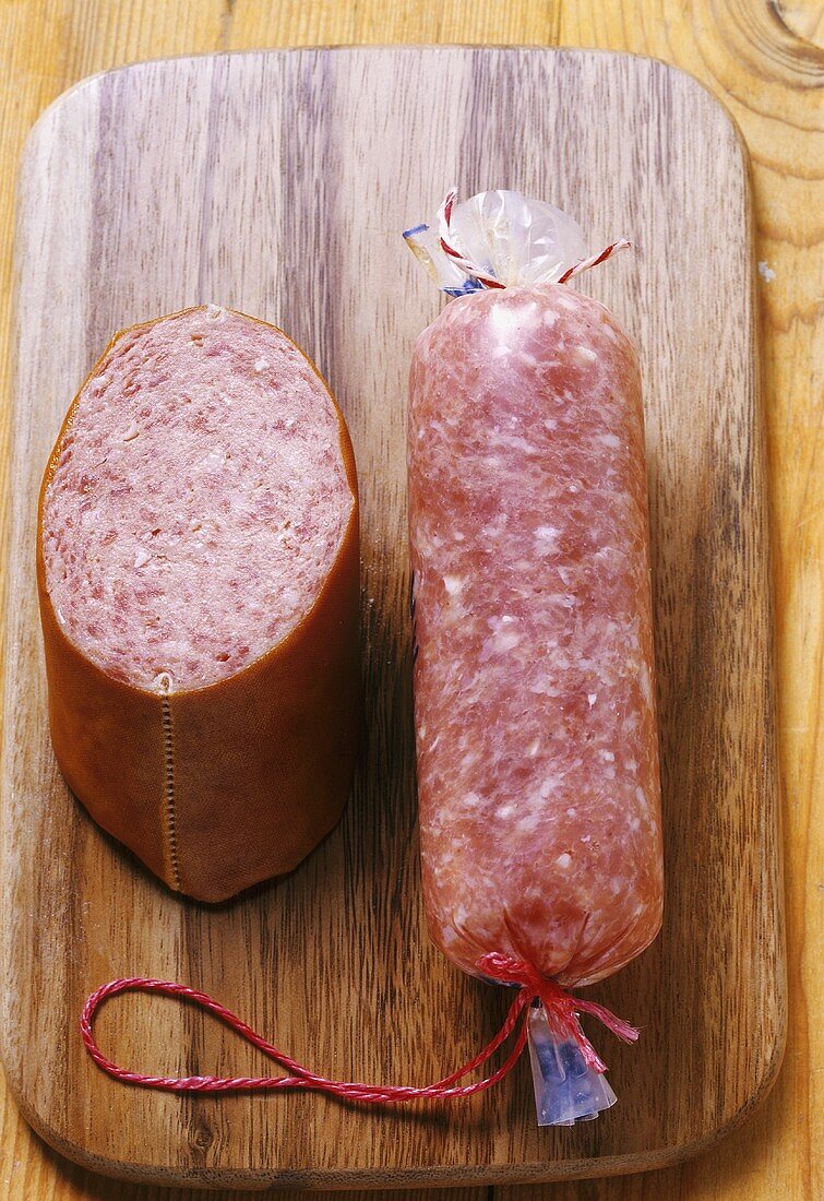 Two different types of Mettwurst (pork sausage) on wooden board