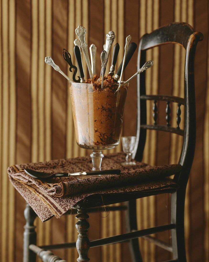 Mousse au chocolat with several spoons in a glass