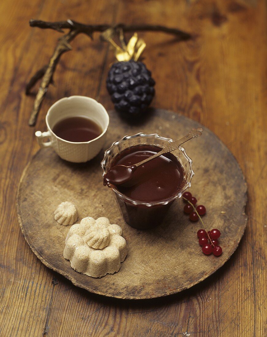 Chocolate and pear jam in a glass on a wooden board