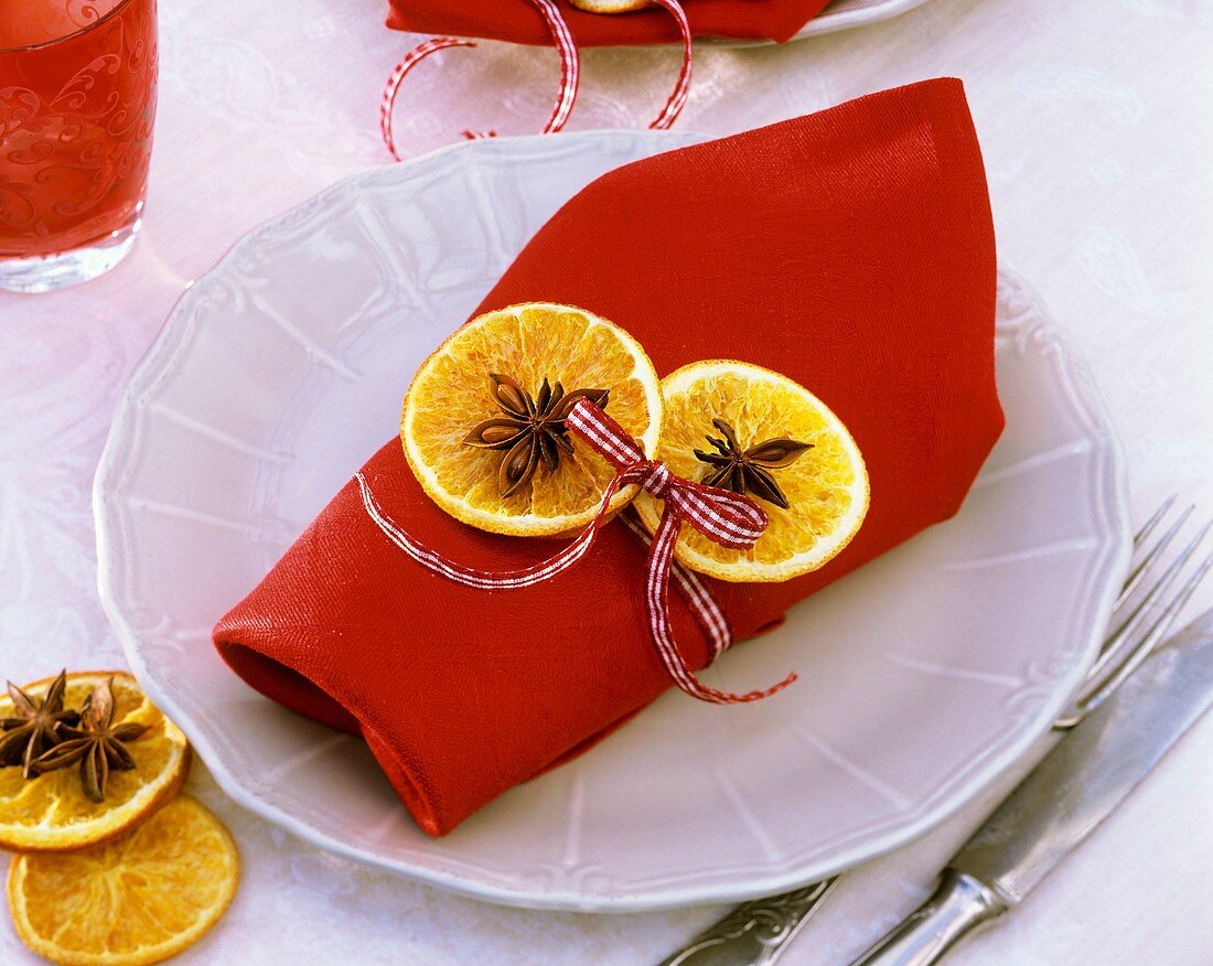 Napkin decorated with dried orange slices and star anise