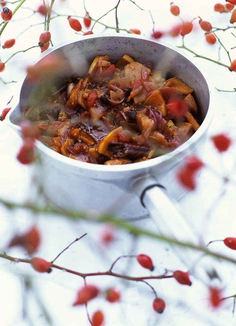 Rose hip and quince chutney in sauteuse pan, rose hips