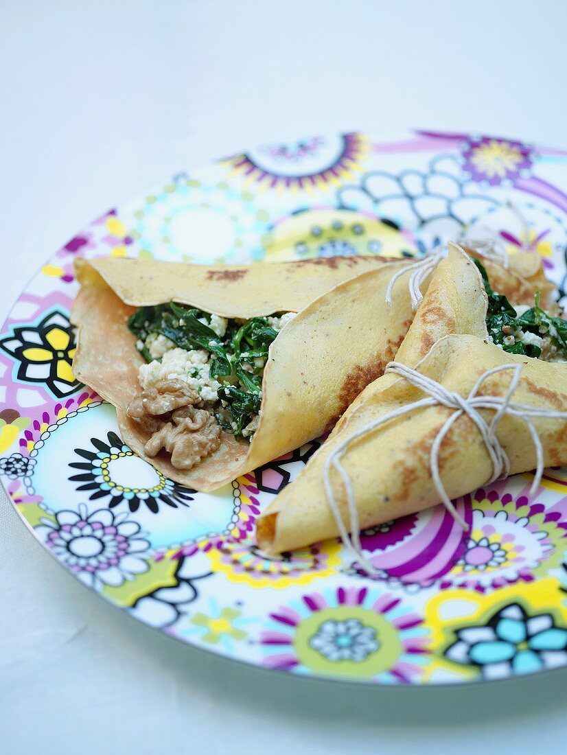 Two crêpes filled with spinach, walnuts and Parmesan