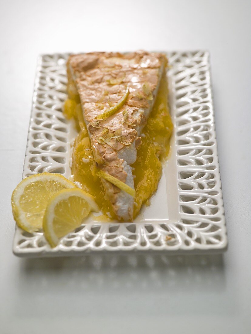 A piece of lemon meringue pie on a ceramic plate