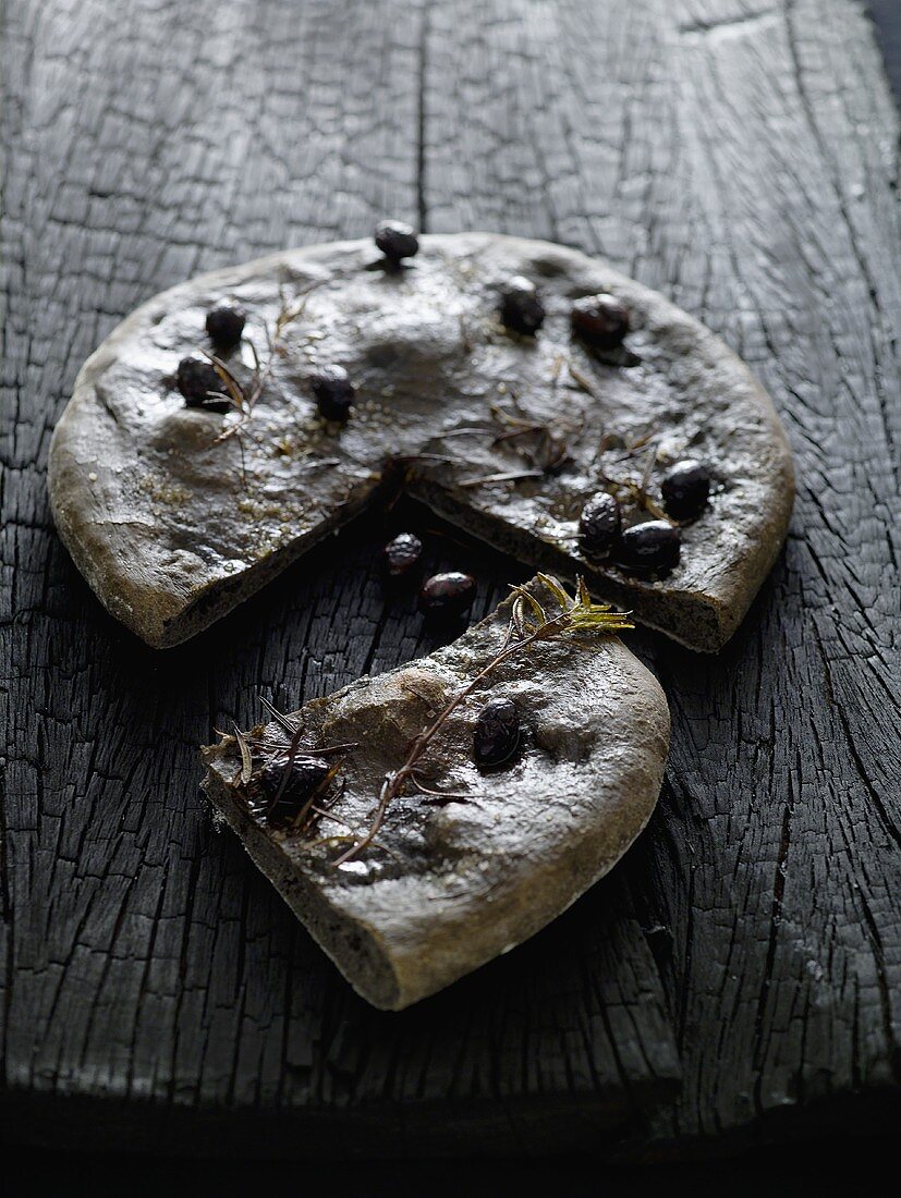 Black focaccia with olives and rosemary