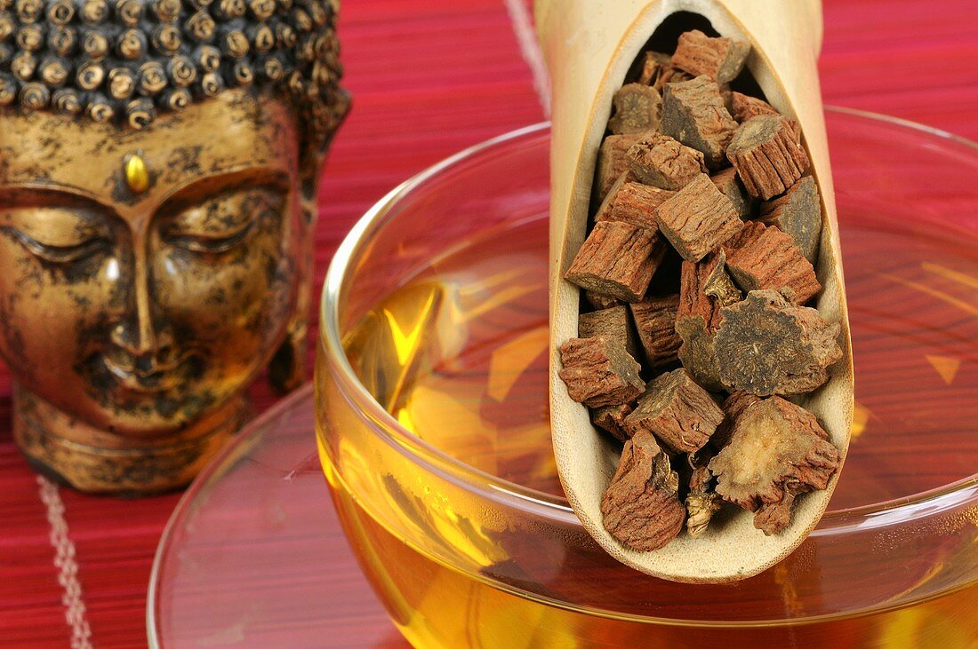 Dried dang shen root in bamboo scoop on tea