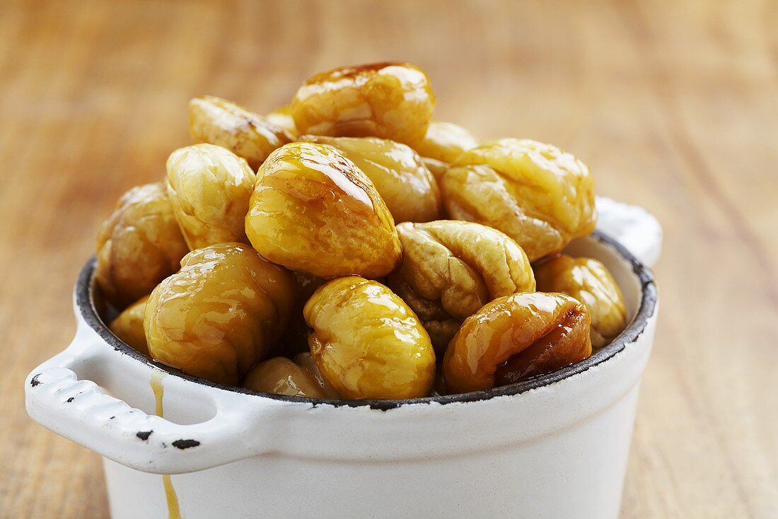 Glazed sweet chestnuts in an enamel pot