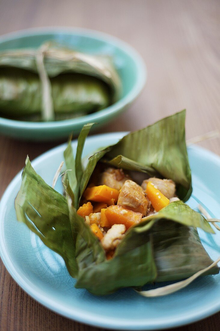 Chicken and pumpkin baked in a banana leaf