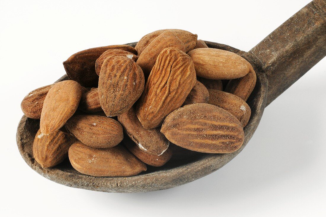 Bitter almonds on a wooden spoon