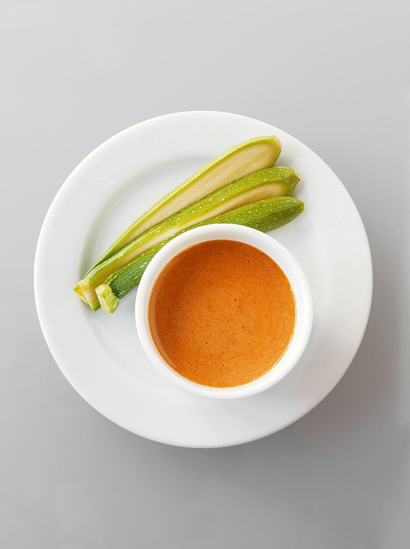 Courgettes with tomato dip on a plate