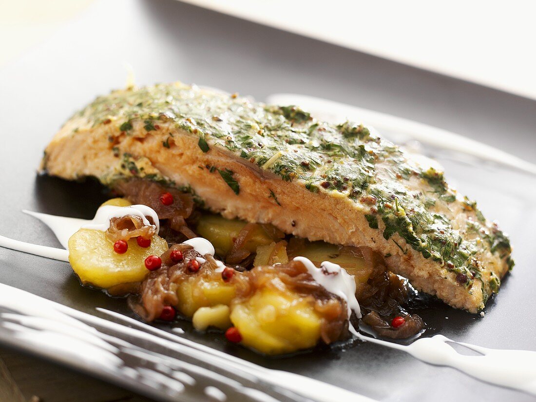 Salmon with herb and mustard crust on fried potatoes