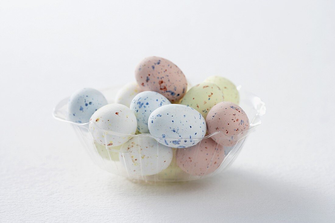 Coloured quails' eggs for Easter in a plastic dish