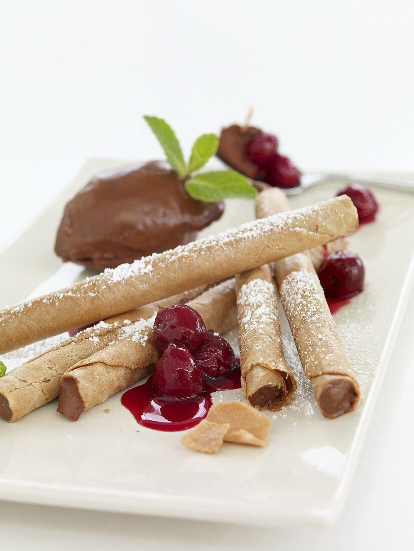 Mousse au chocolat with wafer rolls and cherries