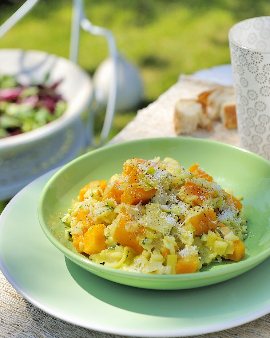 Pumpkin risotto with leeks and herbs out of doors