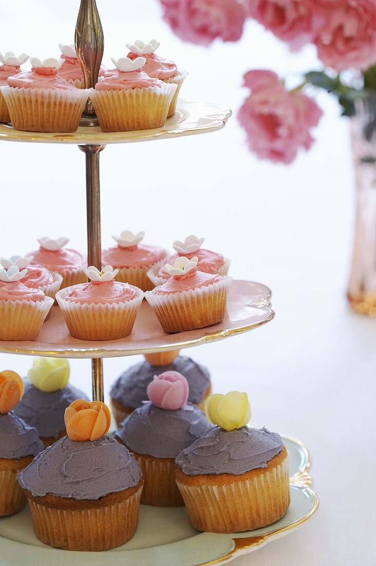 Cupcakes with coloured icing on a tiered stand