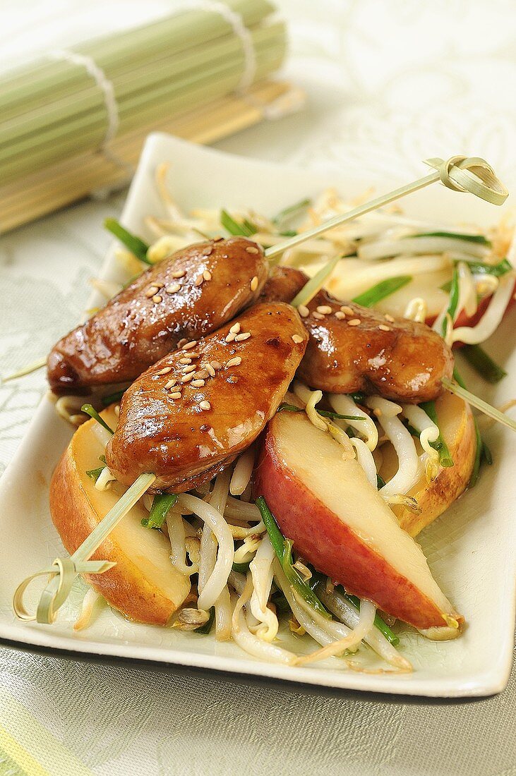 Quail breasts with sesame seeds on pears and soya sprouts