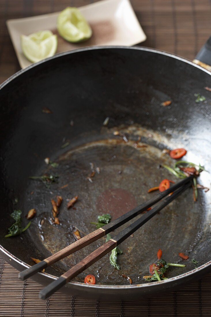 Empty (used) wok with chopsticks