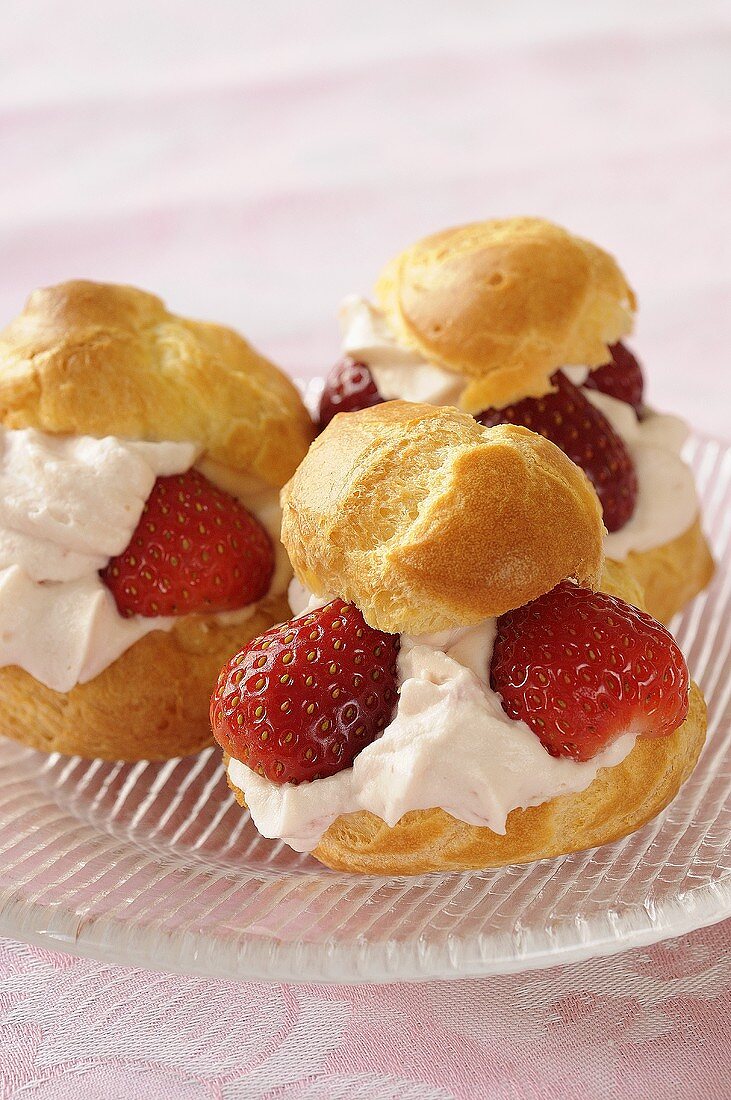 Three profiteroles filled with strawberries & whipped cream