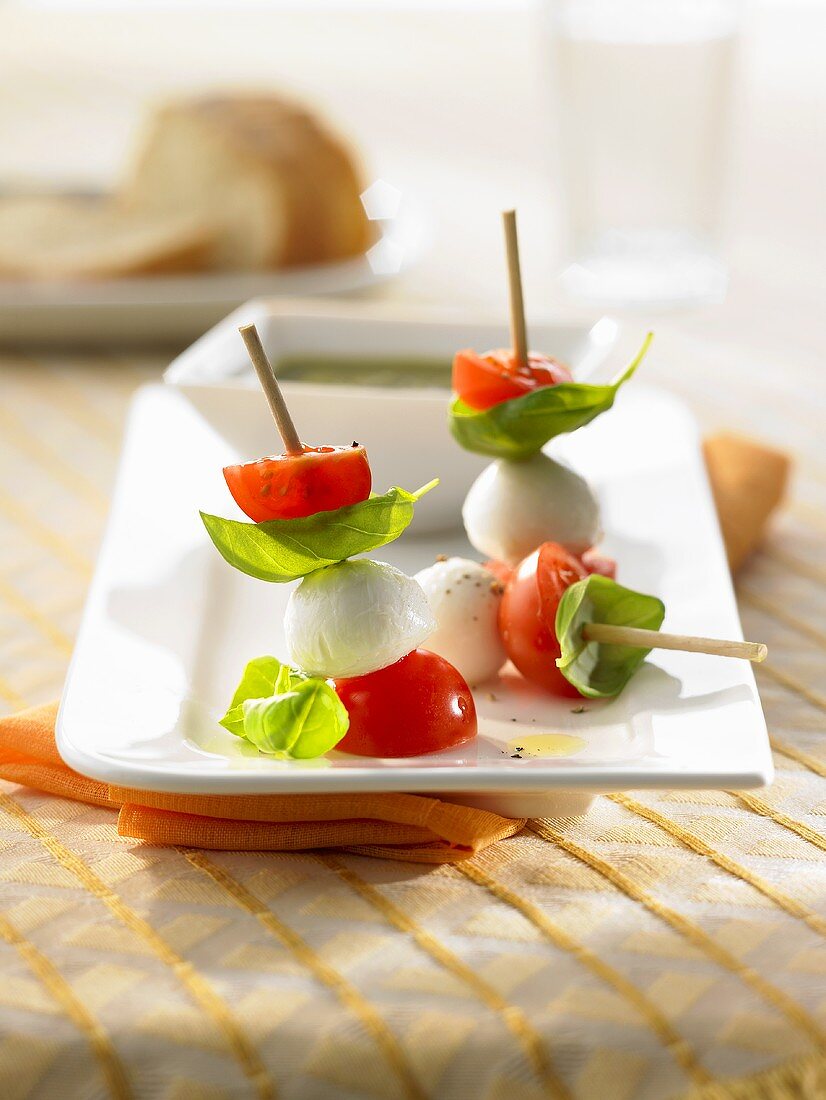 Mozzarella and cocktail tomatoes on three cocktail sticks