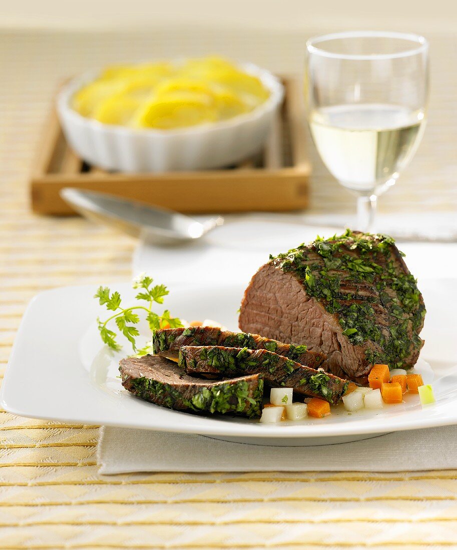 Beef fillet in herb coating with potato gratin
