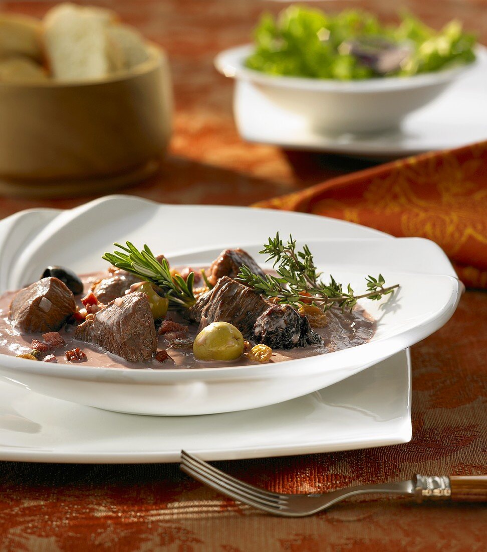 Beef ragout with olives, prunes and herbs