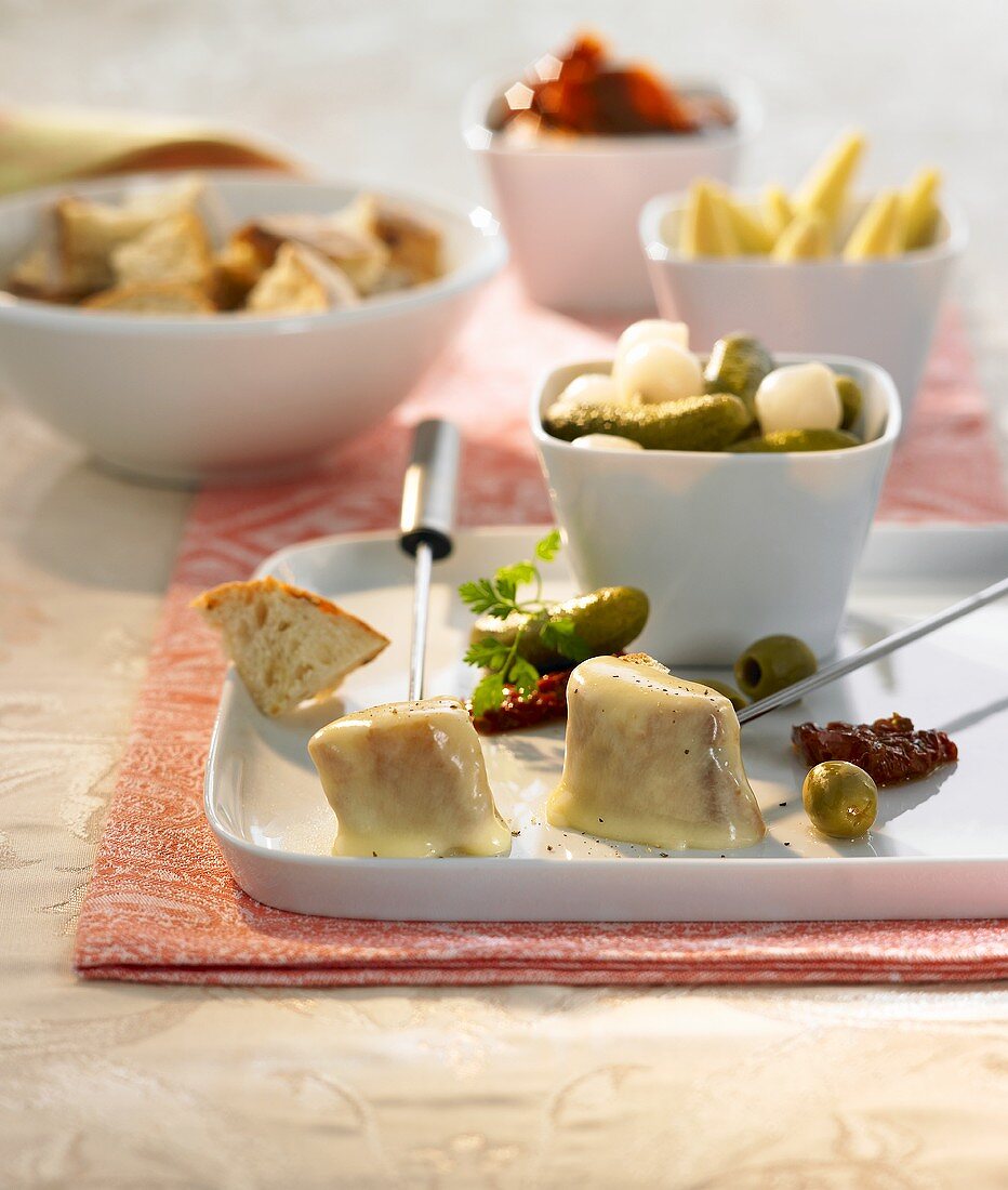 Cheese fondue with mixed pickles